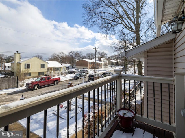 view of snow covered back of property