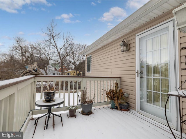 view of snow covered back of property