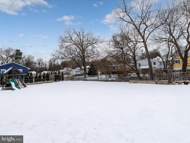 snowy yard with a playground