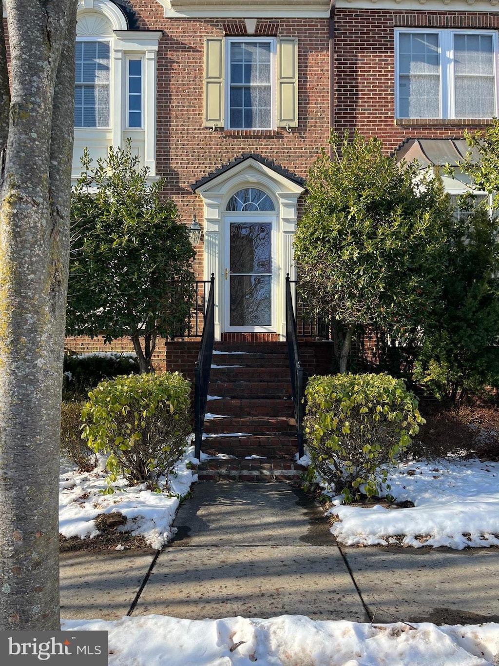 view of snow covered property entrance