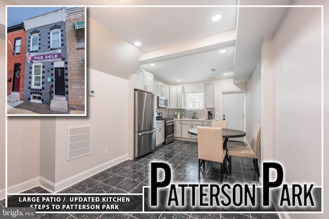 kitchen featuring decorative backsplash, white cabinetry, and stainless steel appliances