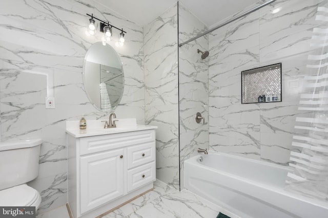 full bathroom featuring vanity, toilet, and tiled shower / bath