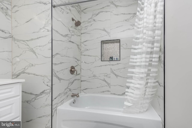 bathroom featuring vanity and tiled shower / bath combo