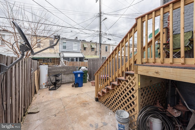 view of patio with a wooden deck and water heater