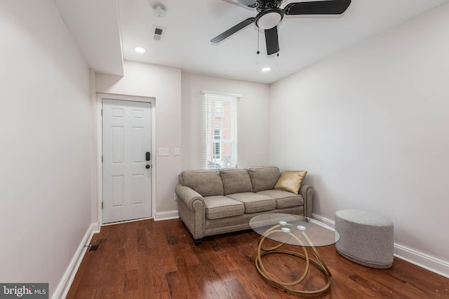 living room featuring dark hardwood / wood-style floors and ceiling fan