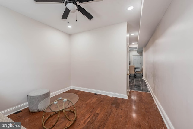 unfurnished room with ceiling fan and dark hardwood / wood-style flooring