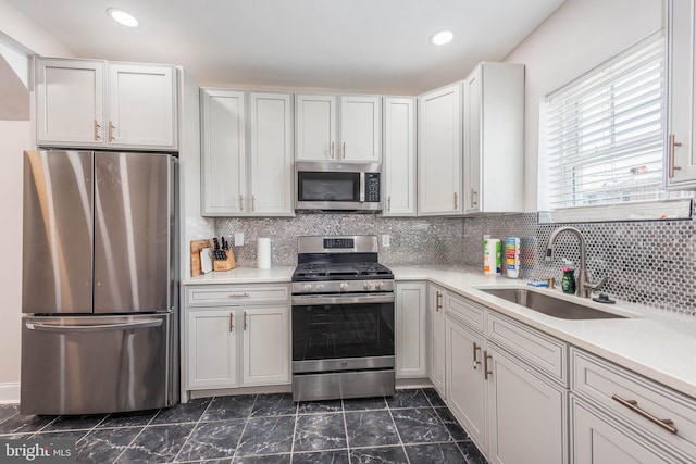 kitchen featuring white cabinetry, sink, and appliances with stainless steel finishes