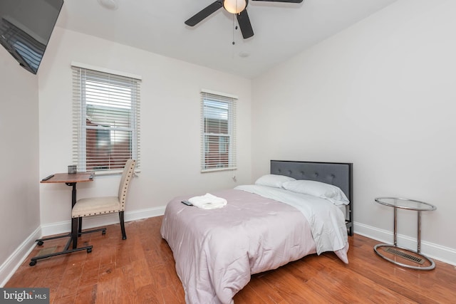 bedroom with ceiling fan and hardwood / wood-style flooring