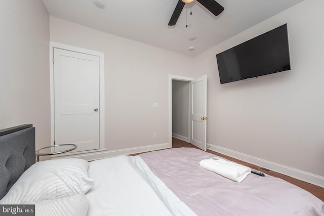 bedroom with ceiling fan and wood-type flooring