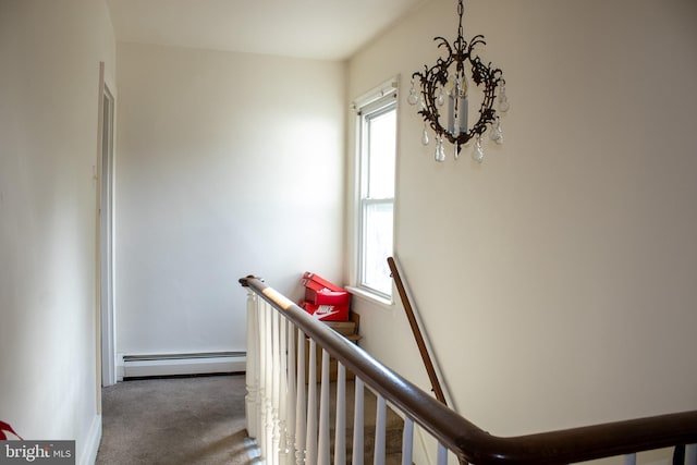 hall featuring dark carpet and a baseboard heating unit