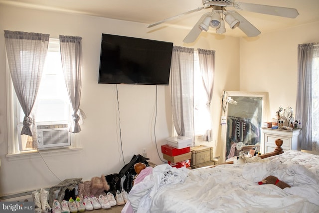 bedroom featuring ceiling fan and cooling unit