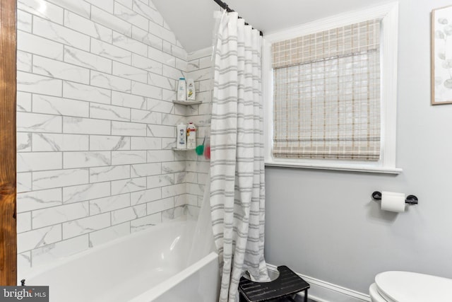 bathroom featuring toilet and shower / tub combo with curtain