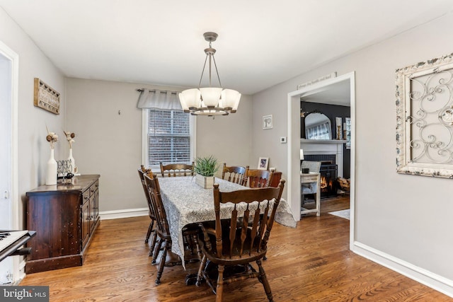 dining area with a chandelier and wood-type flooring