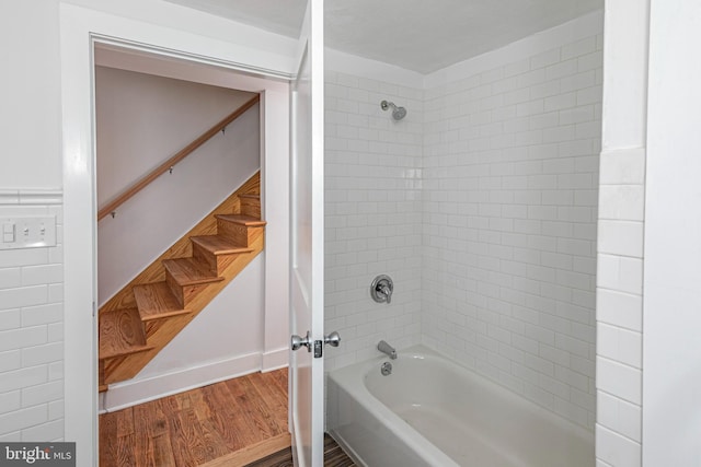 bathroom featuring tiled shower / bath combo and hardwood / wood-style floors