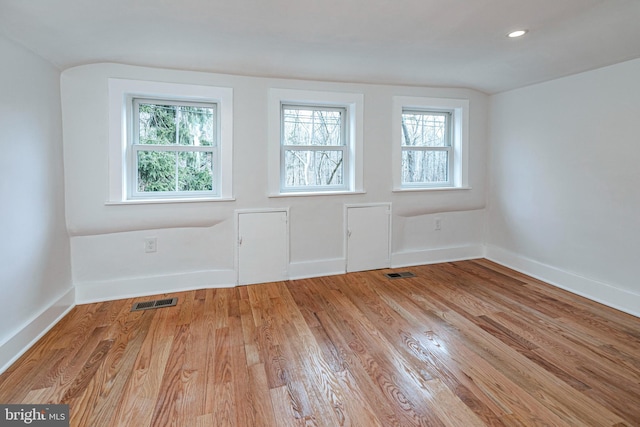 empty room with light hardwood / wood-style flooring