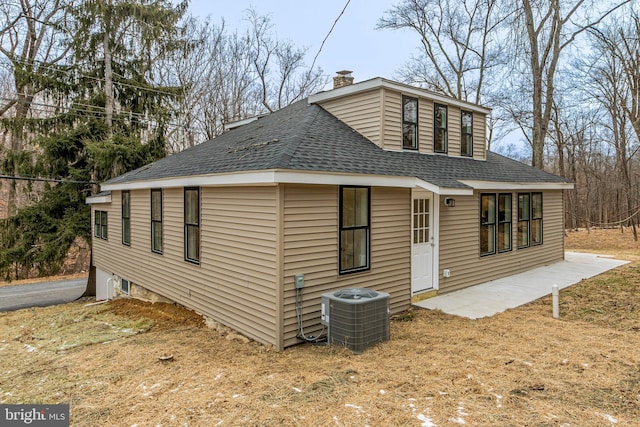 back of property with central AC