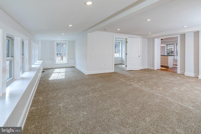 unfurnished living room featuring carpet floors