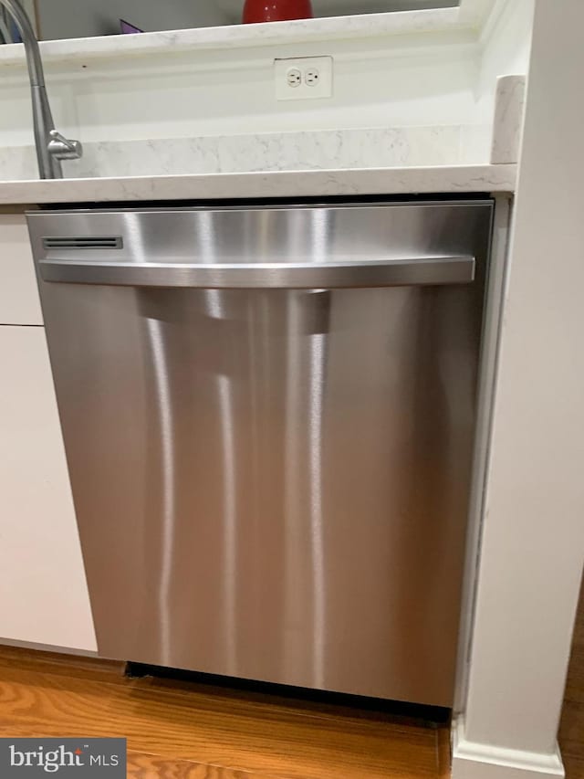 details featuring white cabinets and dishwasher