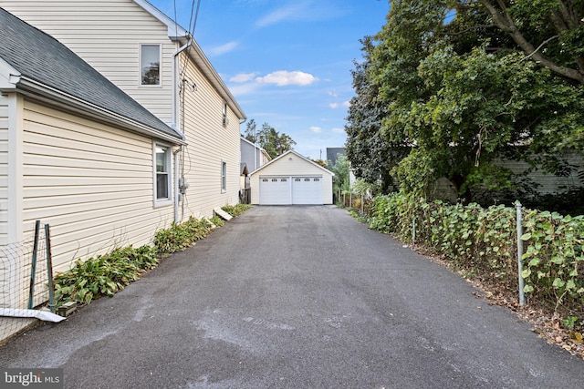 view of home's exterior with a garage and an outdoor structure