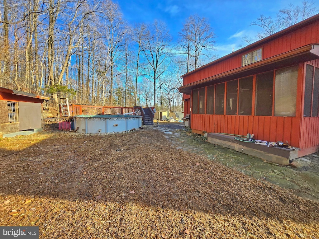 view of side of home featuring a sunroom