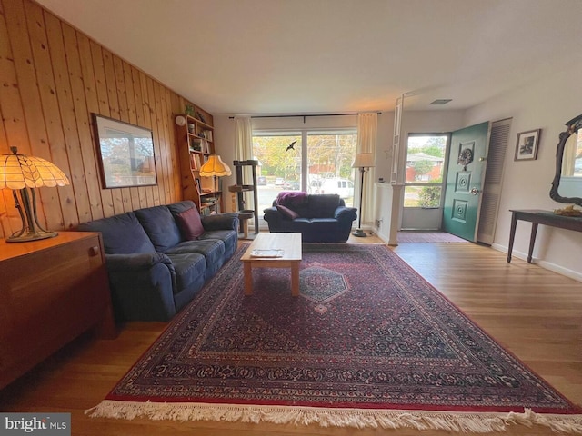 living room featuring wooden walls and light wood-type flooring