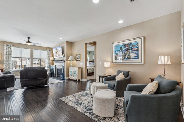 living room with ceiling fan and dark hardwood / wood-style floors