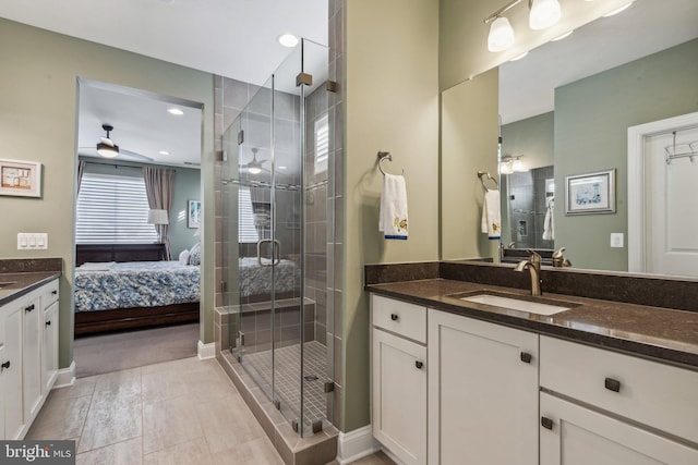 bathroom with vanity, tile patterned floors, ceiling fan, and a shower with shower door