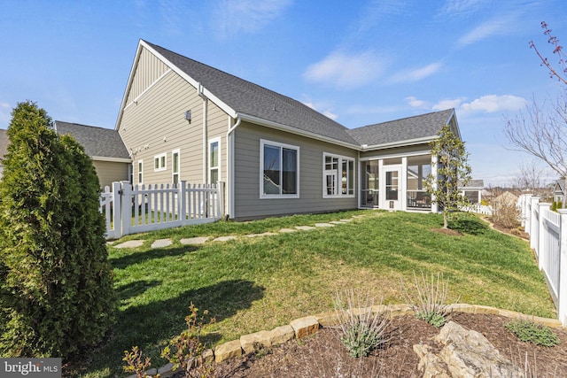 back of house featuring a sunroom and a yard