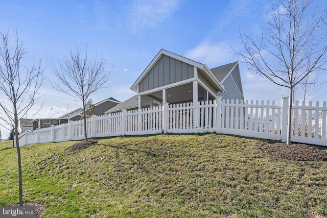 view of front of property with a sunroom and a front lawn