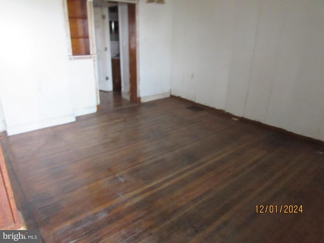 unfurnished room featuring dark hardwood / wood-style flooring