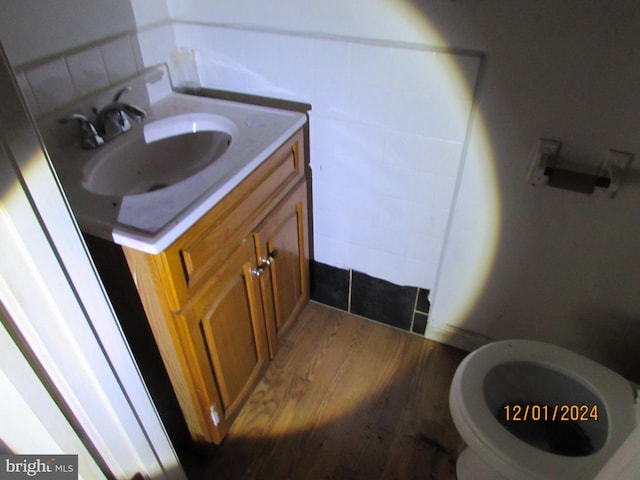 bathroom featuring hardwood / wood-style flooring, vanity, and toilet