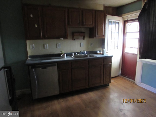 kitchen featuring sink, stainless steel dishwasher, decorative backsplash, dark brown cabinets, and wood-type flooring