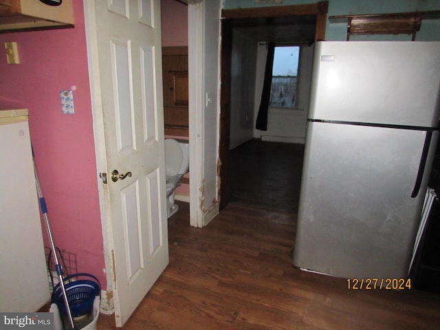 kitchen with stainless steel fridge and dark hardwood / wood-style flooring