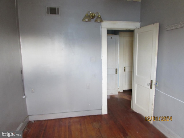 empty room with dark wood-type flooring