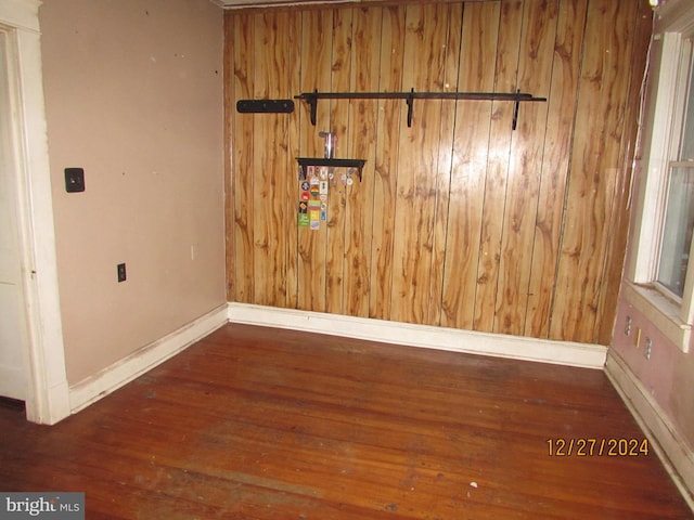 empty room with dark hardwood / wood-style flooring