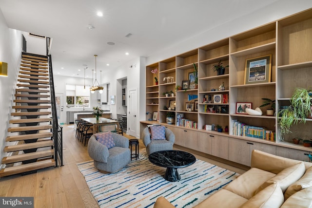 living room with an inviting chandelier, light wood-style flooring, recessed lighting, and visible vents