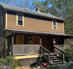 rear view of property with a porch