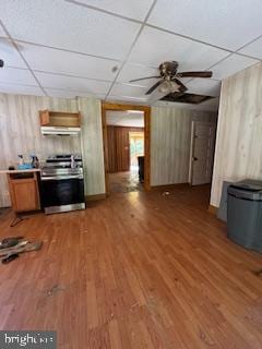 unfurnished living room featuring a drop ceiling, ceiling fan, and wood-type flooring