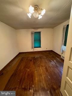 unfurnished room with dark hardwood / wood-style flooring