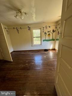 unfurnished room with dark hardwood / wood-style flooring