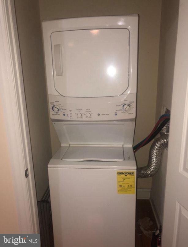 laundry area with stacked washer and dryer