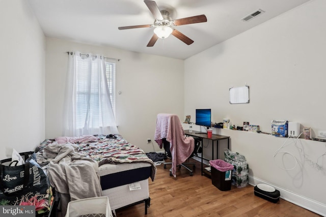 bedroom with hardwood / wood-style flooring and ceiling fan