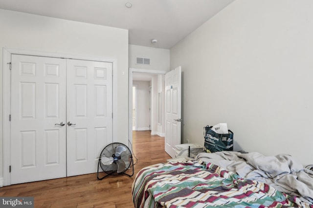 bedroom featuring hardwood / wood-style flooring and a closet