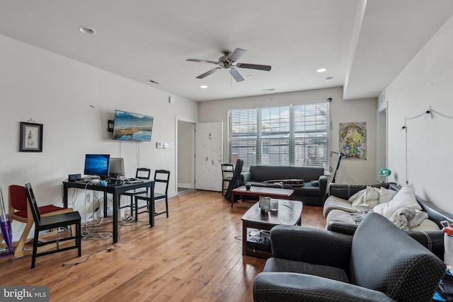 living room with light hardwood / wood-style floors and ceiling fan