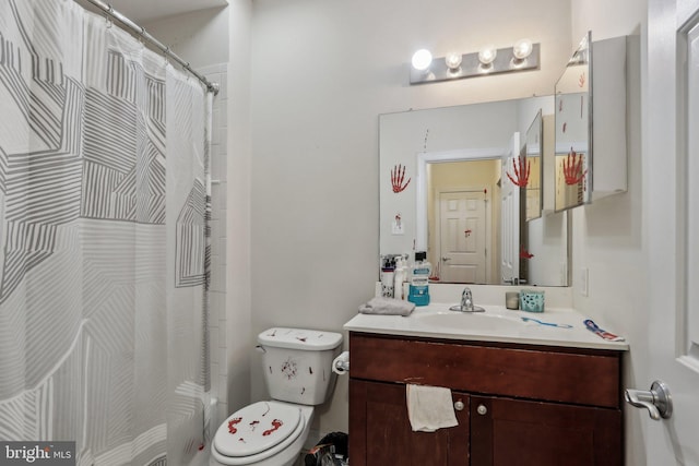 bathroom featuring vanity, toilet, and walk in shower