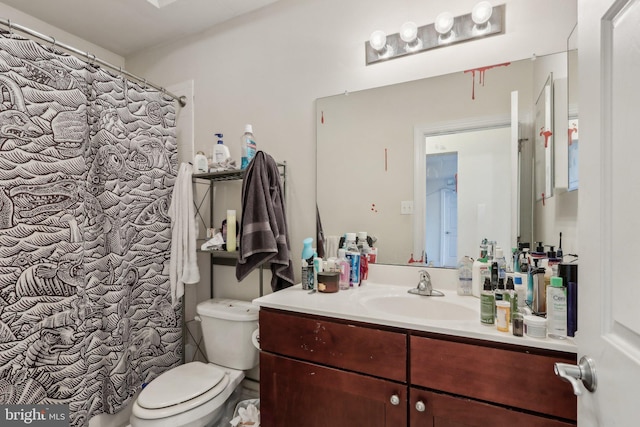 bathroom featuring walk in shower, vanity, and toilet