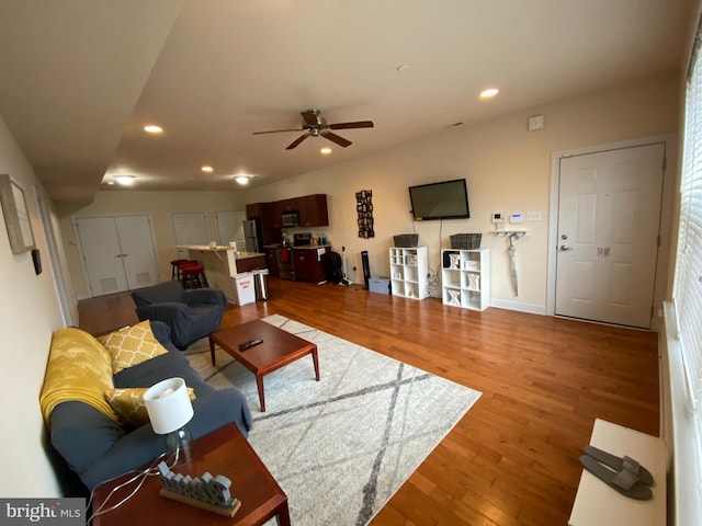 living room with hardwood / wood-style flooring and ceiling fan