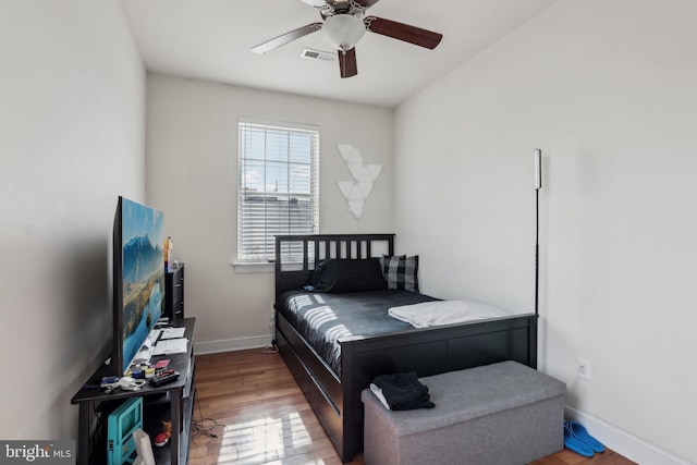 bedroom with hardwood / wood-style flooring and ceiling fan