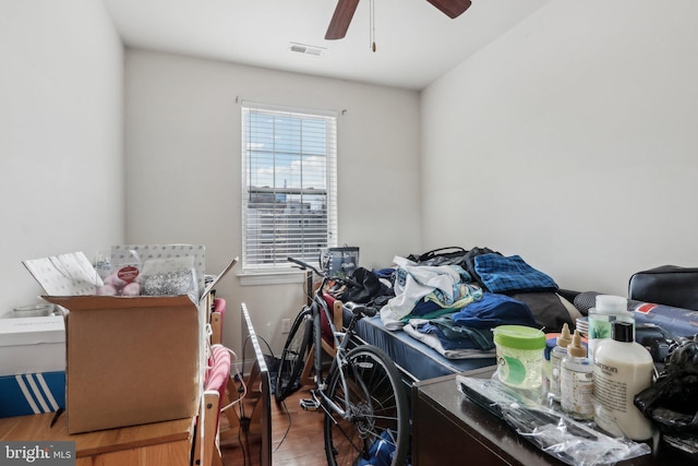 misc room with wood-type flooring and ceiling fan