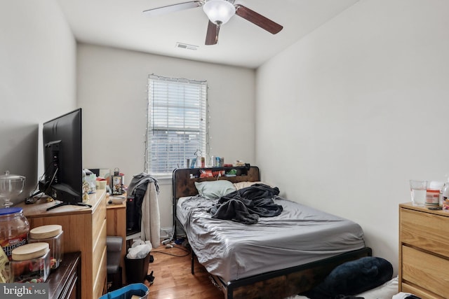 bedroom with hardwood / wood-style floors and ceiling fan